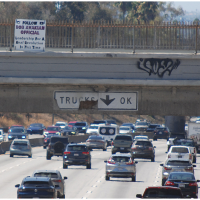 Banner for @BobAvakianOfficial hanging on LA Freeway, September 20, 2024.