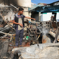 Mohamed al-Dalu points to where his brother, Shaban, burned to death when an Israeli airstrike ignited refugee tents at Al Aqsa Martyrs hospital in the Gaza Strip, October 16, 2024.