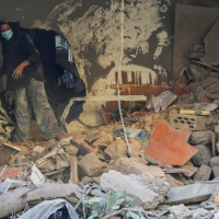 Woman searches for her belongings after Israeli airstrike on Beirut, Lebanon, October 11, 2024.