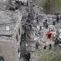 Workers clear the rubble after an overnight Russian attack with guided bombs in Zaporizhzhia, Ukraine, October 21, 2024.