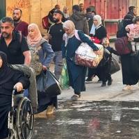 Palestinian refugees traveling on the streets of Gaza fleeing Israeli attacks.