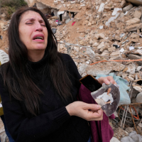 Lebanese woman with a photo of her father, found in the rubble of her destroyed house in Baalbek, eastern Lebanon, November 28, 2024.
