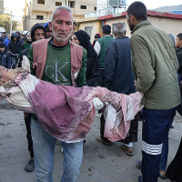 A Palestinian child wounded during the Israeli bombardment of the Gaza Strip is carried to Al-Aqsa Hospital, December 19, 2024.