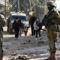 Palestinians displaced by an Israeli military strike on the Jenin refugee camp in the West Bank carry their belongings, January 23, 2025.