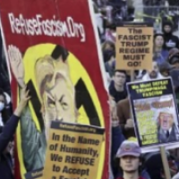 Refuse Fascism Hitler banner in middle of protest. "In the name of humanity, we refuse to accept a fascist America. 