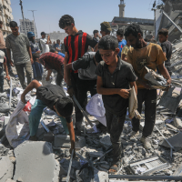 Palestinians search the rubble after an Israeli airstrike demolished a high-rise building in Gaza City, September 5, 2025.