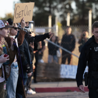 Protesters rally against federal troops in Oakland, California, October 23, 2025.