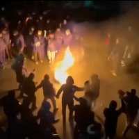Screengrab from AP video of protesters dancing around fire in Iran, January 9, 2026.