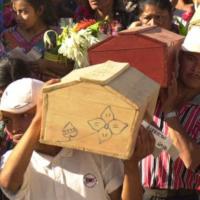 Relatives carry coffins of bodies exhumed in 2001, who were victims of a 1982 massacre by Guatemalan military at the Mayan town of Santo Tomas Chiche.