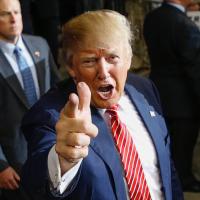 Donald Trump pointing his finger like a gun.