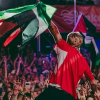 Mackelmore crowd-surfing with Palestinian flag
